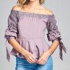 A girl stand in a Crochet Off The Shoulder Blouse