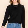 A woman in a black colour Crop sweatshirt Top