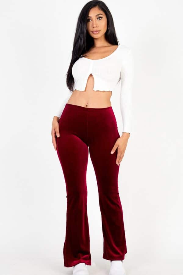 A woman wearing a short top and velvet pants